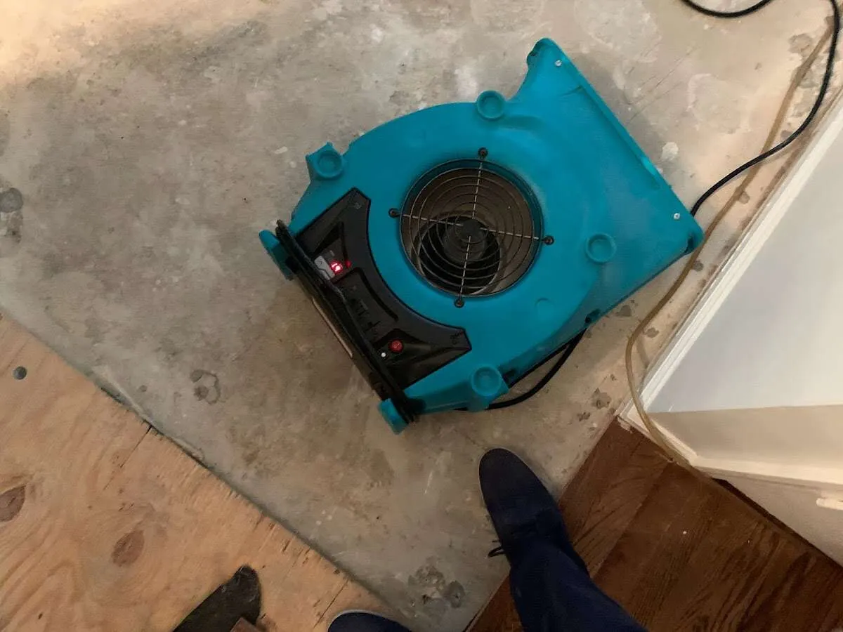 Air mover drying subfloor during Commercial Water Damage Restoration in Rockport